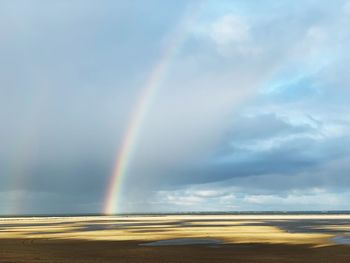 Rainbow over sea against sky