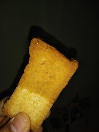 Close-up of burger against black background