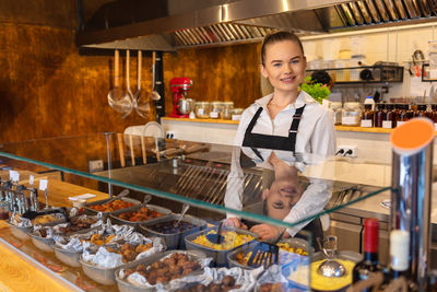 Portrait of a smiling young woman in store