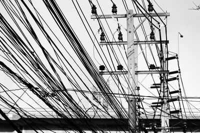 Low angle view of electricity pylon against sky