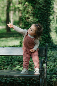 Full length of boy playing with arms raised