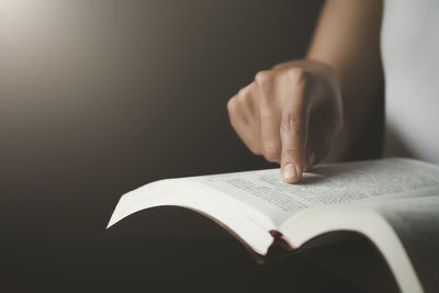 Midsection of person reading book