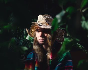 Close-up portrait of young woman wearing hat