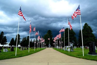 American flags both sides on footpath at cemetery