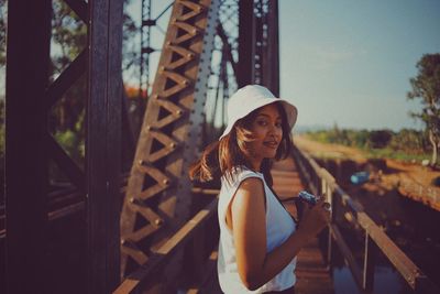 Portrait of smiling young woman standing outdoors