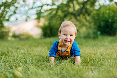 Portrait of cute boy in grass