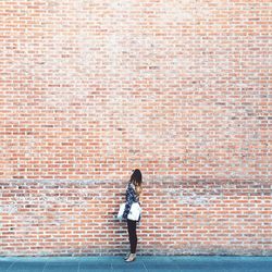 Full length of man standing on wall