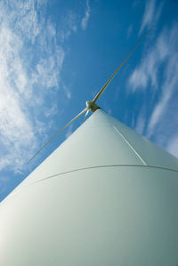 Low angle view of windmill against blue sky