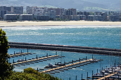 High angle view of swimming pool by buildings in city