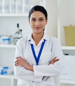 Portrait of young woman standing in hospital