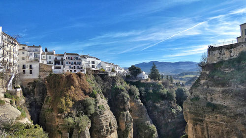 Panoramic view of buildings and mountains against sky