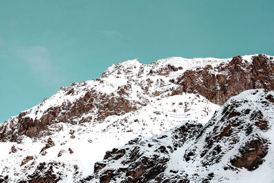 Low angle view of snowcapped mountain against sky