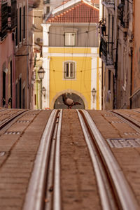 Railroad tracks amidst buildings in city