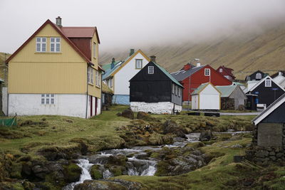 Houses by stream in town