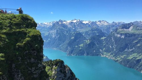 Scenic view of mountains against blue sky