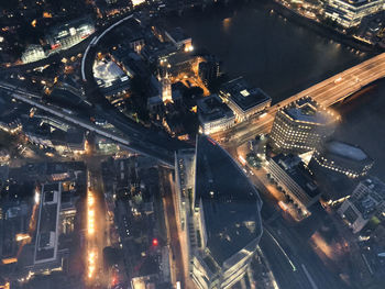 High angle view of illuminated city street and buildings at night