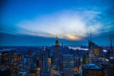 View of cityscape against cloudy sky