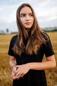 Woman in black dress outdoors in the field