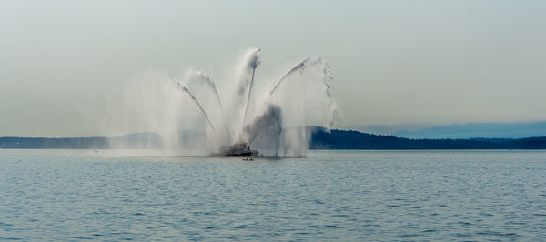 Water sprays out of a fire boat near seattle, washington.