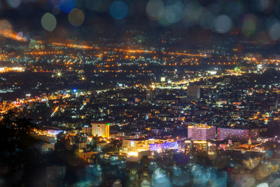 High angle view of illuminated city buildings at night