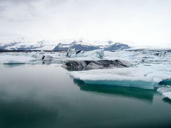 Close-up of frozen lake against sky