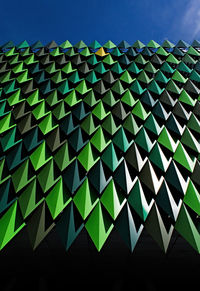 Close-up of modern building against blue sky