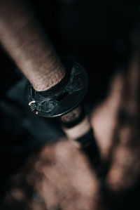 Close-up of human hand holding metal