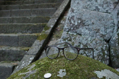 High angle view of eyeglasses on stone wall