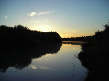 Scenic view of lake against sky during sunset