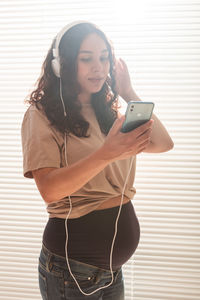 Portrait of young woman using mobile phone