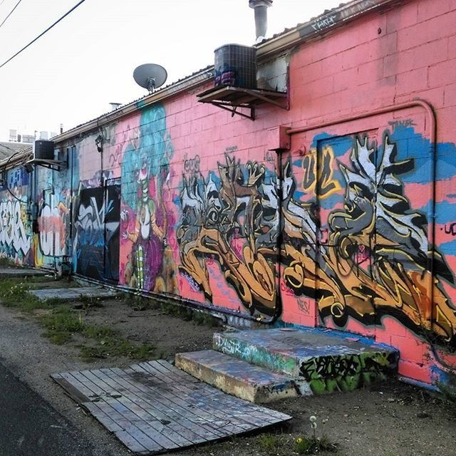 graffiti, art, creativity, art and craft, architecture, built structure, building exterior, wall - building feature, street art, human representation, text, multi colored, street, vandalism, mural, wall, outdoors, day, building