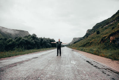 Full length of young man standing on road