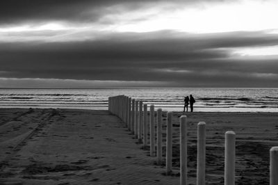 Man standing on beach against sky