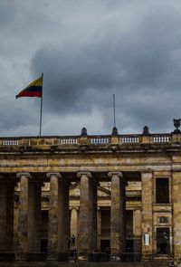 Low angle view of historical building against cloudy sky