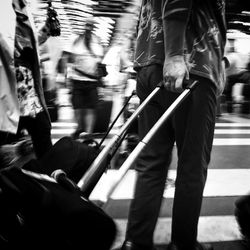 Low section of people standing on tiled floor