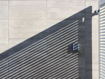 Shadow of railing on wall of building