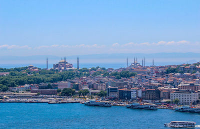 View of cityscape against blue sky