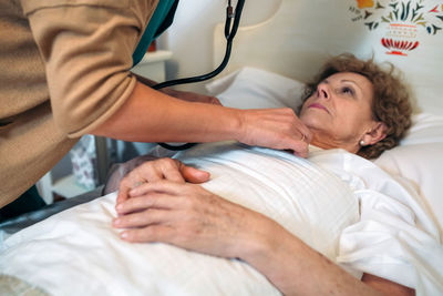 Midsection of man lying on bed