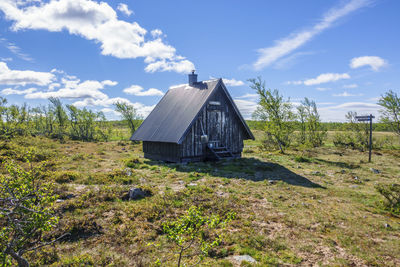 Built structure on field against sky