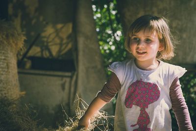 Smiling girl carrying straw