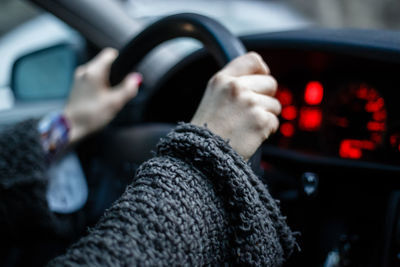 Cropped image of hand driving car