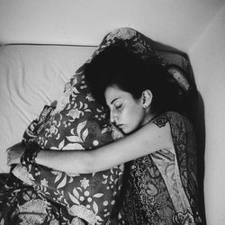 Young woman sitting on sofa at home