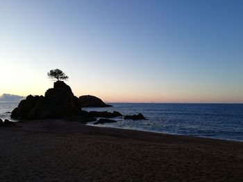 Scenic view of sea against clear sky during sunset