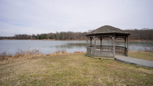 Built structure by lake against sky