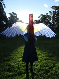 Woman standing on field against sky