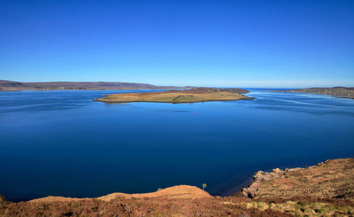 Scenic view of lake against blue sky