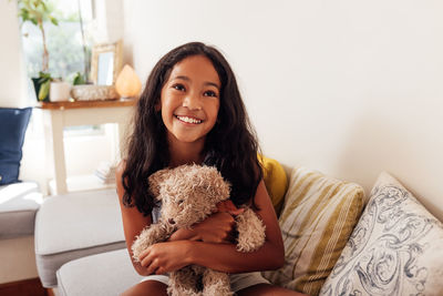 Portrait of young woman with teddy bear