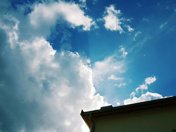 Low angle view of building against cloudy sky