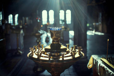 Close-up of illuminated lamp on table