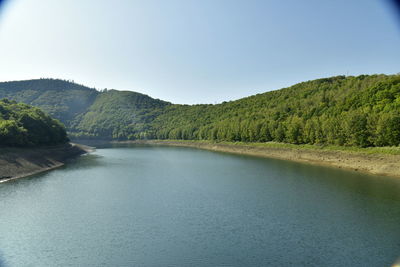 Scenic view of lake and mountains against clear sky